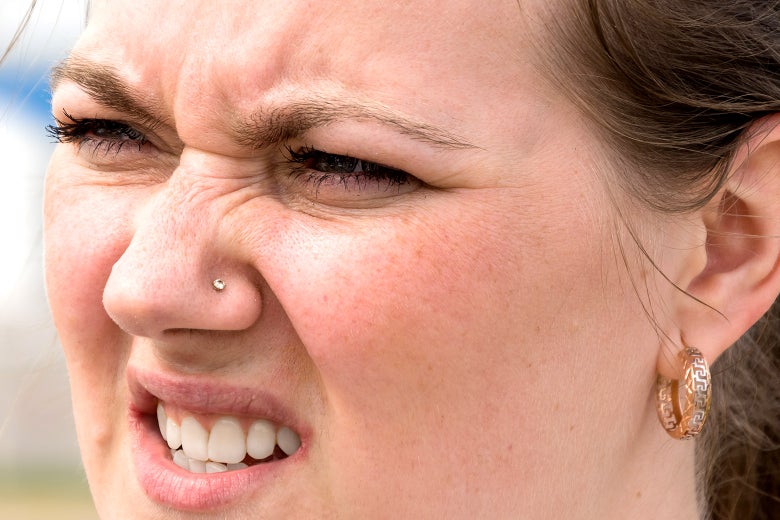 A woman squinting.
